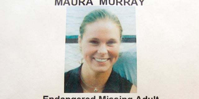 This Feb. 4, 2014 photo shows a missing person poster of Maura Murray that hangs in the lobby of the police station in Haverhill, New Hampshire.