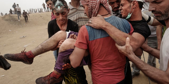 A wounded Palestinian protester is taken away during clashes with Israeli forces on May 4, 2018 in Khan Yunis, Gaza.
