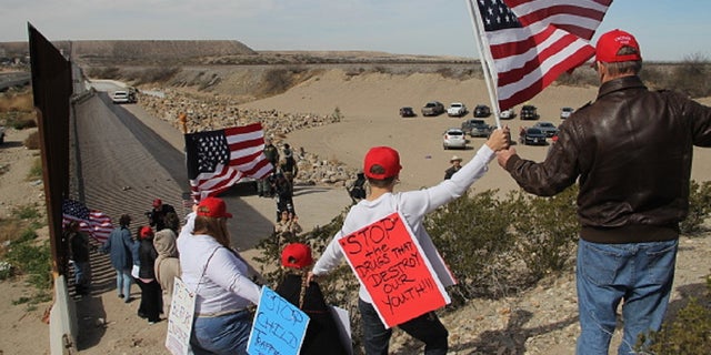 Supporters of the U.S. Republican Party make a human wall to demonstrate in favor of the construction of the border wall between the United States and Mexico, at the border between Sunland Park, New Mexico, United States and Ciudad Juarez, Chihuahua state, Mexico, on February 9, 2019. [Photo by Herika Martinez / AFP) (Photo credit should read HERIKA MARTINEZ/AFP/Getty Images)