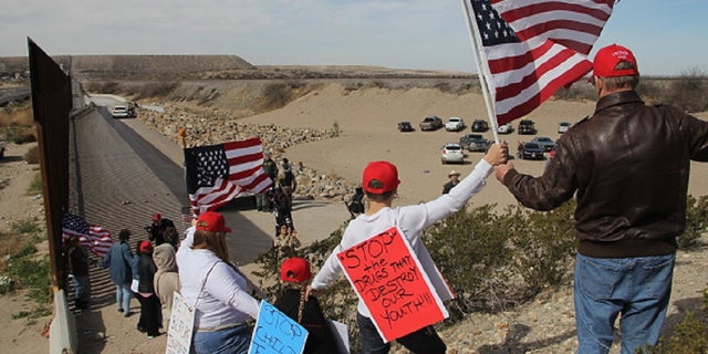 Supporters of the U.S. Republican Party make a human wall to demonstrate in favor of the construction of the border wall between the United States and Mexico, at the border between Sunland Park, New Mexico, United States and Ciudad Juarez, Chihuahua state, Mexico, on February 9, 2019. (Photo by Herika Martinez / AFP) (Photo credit should read HERIKA MARTINEZ/AFP/Getty Images)