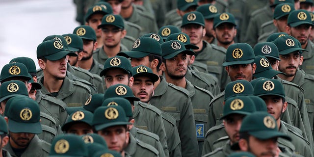 Members of the Iranian Revolutionary Guard arrive on Monday for a ceremony celebrating the 40th anniversary of the Islamic revolution in Tehran, Iran.  The co-conspirators named in the indictment are accused by the Justice Department of working on behalf of the military unit.