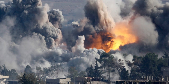 Smoke rises over Syrian town of Kobani after an airstrike, as seen from the Mursitpinar border crossing on the Turkish-Syrian border in the town of Suruc in this file October 18, 2014 file photo.