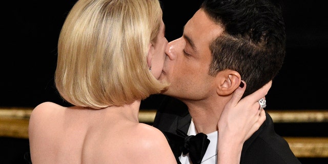 Lucy Boynton, left, kisses Rami Malek in the audience after he is announced winner of the award for best performance by an actor in a leading role for "Bohemian Rhapsody" at the Oscars on Sunday, Feb. 24, 2019, at the Dolby Theatre in Los Angeles. (Photo by Chris Pizzello/Invision/AP)
