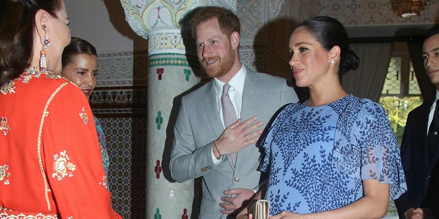 Britain's Prince Harry and Meghan, the Duchess of Sussex, are greeted by Princess Lalla Meryem of Morocco second left and Princess Lalla Hasna of Morocco, at the residence of King Mohammed VI of Morocco, on the third day of their tour of Morocco, in Rabat, Monday, Feb. 25, 2019. (Yui Mok/Pool Photo via AP)