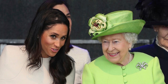 Britain's Queen Elizabeth II and Meghan, the Duchess of Sussex, left, attend the opening of the new Mersey Gateway Bridge, in Widnes, northwest England, Thursday, June 14, 2018.