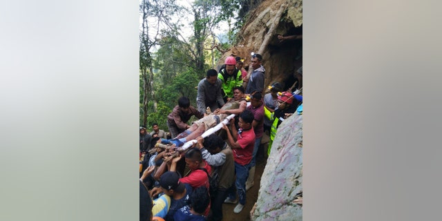 The collapse of an unlicensed gold mine in Indonesia's North Sulawesi province has buried dozens of people, a disaster official said