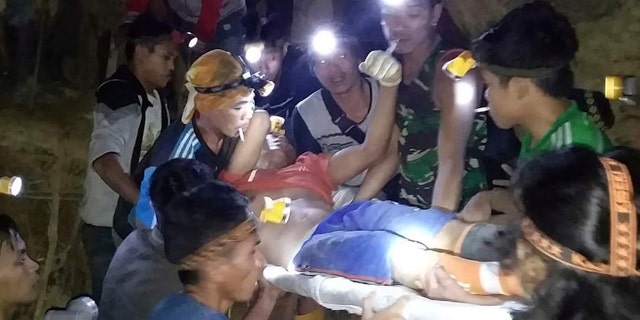 In this undated photo released by Indonesian Search And Rescue Agency (BASARNAS) rescuers evacuate a survivor from a collapsed gold mine in Bolaang Mongondow, North Sulawesi, Indonesia.