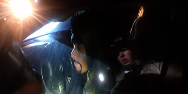 Napa County Sheriff's Deputy Riley Jarecki can be seen in a refection on the window of a car, asking Javier Hernandez Morales to roll down the window.