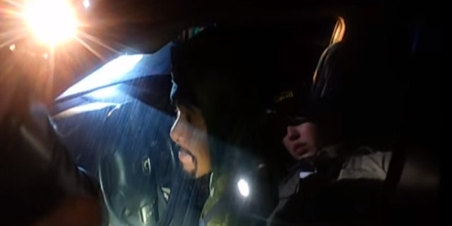 Napa County Sheriff's Deputy Riley Jarecki can be seen in a refection on the window of a car, asking Javier Hernandez Morales to roll down the window.