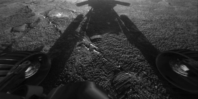 NASA's Mars rover Opportunity reveals its shadow, seen on July 26, 2004, and snapped by the rover’s front hazard-avoidance camera. At the time, Opportunity was moving farther into Endurance Crater in the Meridiani Planum region of Mars.