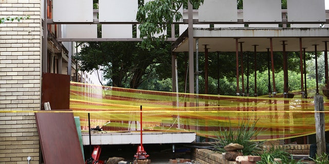 Police tape cordons off the site of a walkway collapse at the Driehoek High School in Vanderbijlpark, South Africa, Friday, Feb. 1, 2019. At least 3 students were killed and scores injured at the school near Johannesburg, a South African official said. (AP Photo)