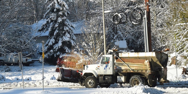 A City of Olympia sanding truck makes it way up a street on Sunday, Feb. 10, 2019, in Olympia, Wash.