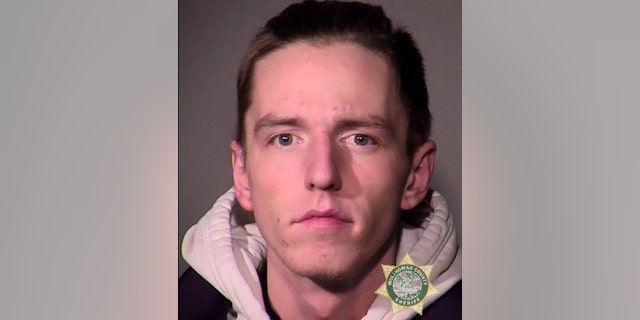 Douglas B. Smyser, 21, was arrested Wednesday in Portland after his disturbing behavior forced a LA-bound plane to divert, a complaint said.
