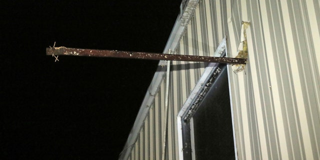 A metal pipe passes through the exterior wall of Fast Dog Printing Co. on Conway Drive in Columbus, Missouri, after a tornado hit the area on Saturday, February 23, 2019.