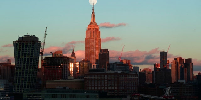 The almost full super snow moon rises at sunset behind the Empire State Building and Chrysler Building in New York City on Feb. 18, 2018 photographed from Hoboken, New Jersey. (Gary Hershorn/FOX News)