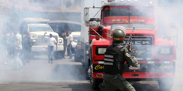 Lawmaker members of the Venezuelan National Assembly and supporters of Juan Guaido, who many nations have recognized as the country's rightful interim ruler, clash with security forces as they block the road on the outskirts of Mariara, Venezuela February 21.