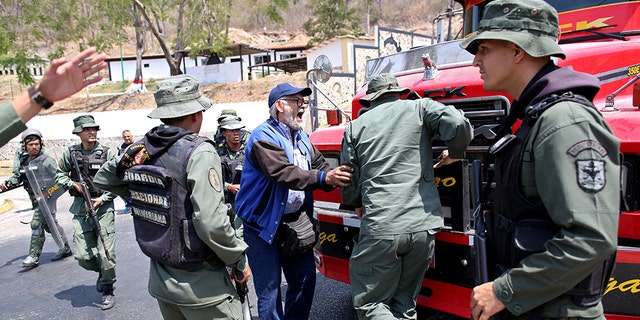 National guardsmen in anti-riot gear positioned a trailer truck in front of a tunnel, blocking the highway westward. A shouting match and scuffle ensured, with the guardsmen firing tear cag before the lawmakers eventually forced their way through and resumed their journey.