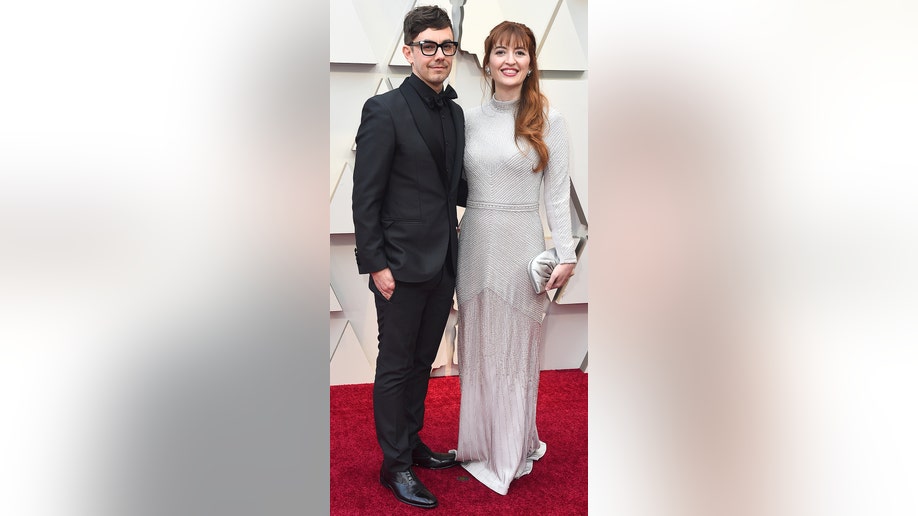 Jorma Taccone, left, and Marielle Heller arrive at the Oscars on Sunday, Feb. 24, 2019, at the Dolby Theatre in Los Angeles. (Photo by Jordan Strauss/Invision/AP)