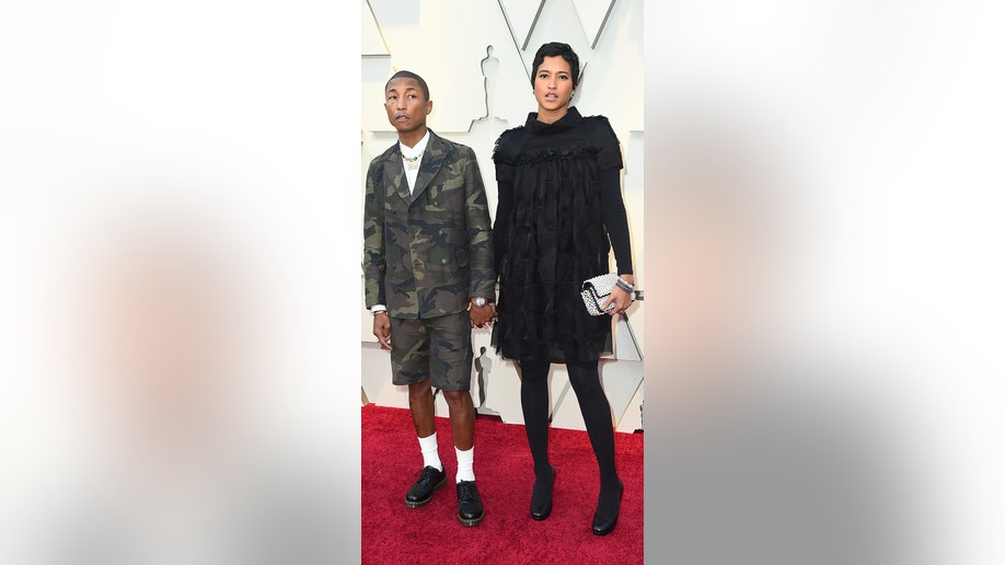 Pharrell Williams, left, and Helen Lasichanh arrives at the Oscars on Sunday, Feb. 24, 2019, at the Dolby Theatre in Los Angeles. (Photo by Jordan Strauss/Invision/AP)
