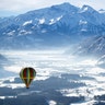 A hot air balloon makes its way above Zell am See, Austria, Feb. 5, 2019. 