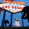 A man takes a picture of a small snowman at the "Welcome to Fabulous Las Vegas" sign along the Las Vegas Strip, Feb. 21, 2019. 