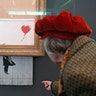 People look at the shredded Banksy painting "Love is in the Bin" at the Museum Frieder Burda in Baden-Baden, Germany, Feb. 5, 2019, 