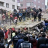 Rescue workers and people try to remove debris of an eight-story building which collapsed in Istanbul, Feb. 6, 2019. 