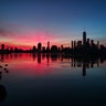 The sun rises behind lower Manhattan and One World Trade Center in New York City, Feb. 2, 2019.