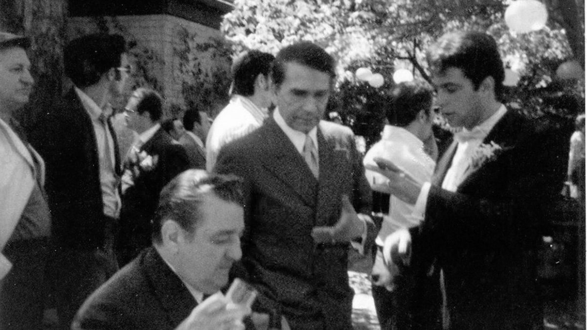 (L to R foreground) On the wedding set of "The Godfather," one of Joe Columbo's enforcers (seated), Richard Conte and Gianni Russo (standing.)