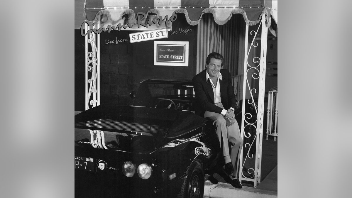 Gianni Russo, seated on the black Ferrari parked in front his State Street Club, poses for the album cover art, "Live from State Street."