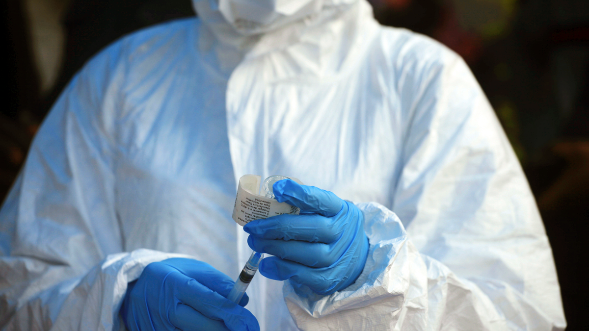 In this file photo, a healthcare worker from the World Health Organization prepares to give an Ebola vaccination in Mangina, Democratic Republic of Congo.