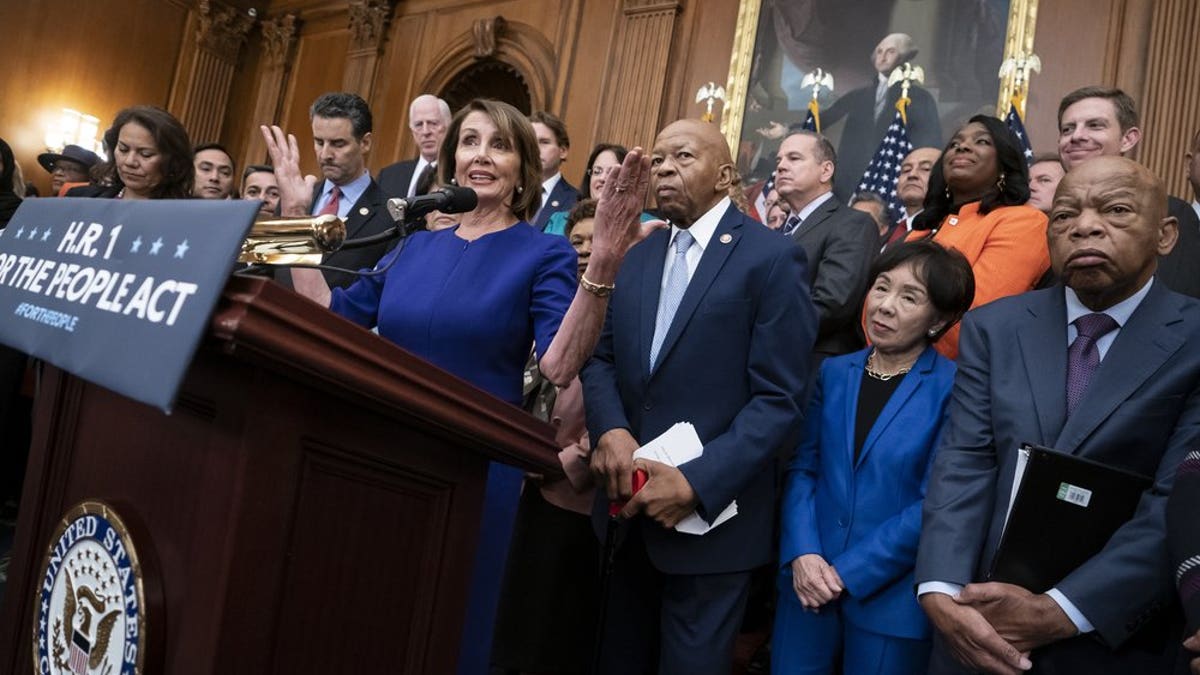 Speaker of the House Nancy Pelosi of Calif., and House Democrats, now in the majority, unveil a comprehensive elections and ethics reform package that targets what they call a "culture of corruption in Washington" and aims to reduce the role of money in politics, at the Capitol in Washington, Friday, Jan. 4, 2019. She is joined from left by Rep. Veronica Escobar, D-Texas, Rep. John Sarbanes, D-Md., Rep. Elijah Cummings, D-Md., chairman of the Committee on Oversight and Government Reform, Rep. Doris Matsui, D-Calif., and Rep. John Lewis, D-Ga. (AP Photo/J. Scott Applewhite)