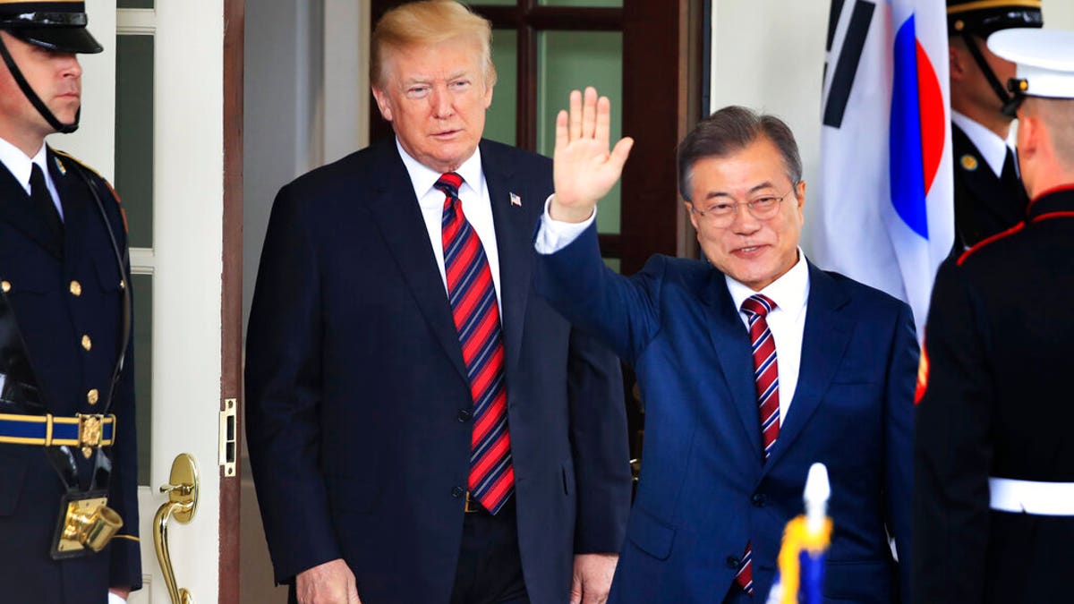 FILE: South Korean President Moon Jae-in waves as he is welcomed by U.S. President Donald Trump to the White House in Washington on May 22, 2018.