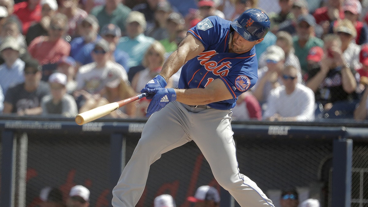 Tim Tebow bats in the first inning during an exhibition spring training baseball game against the Washington Nationals.