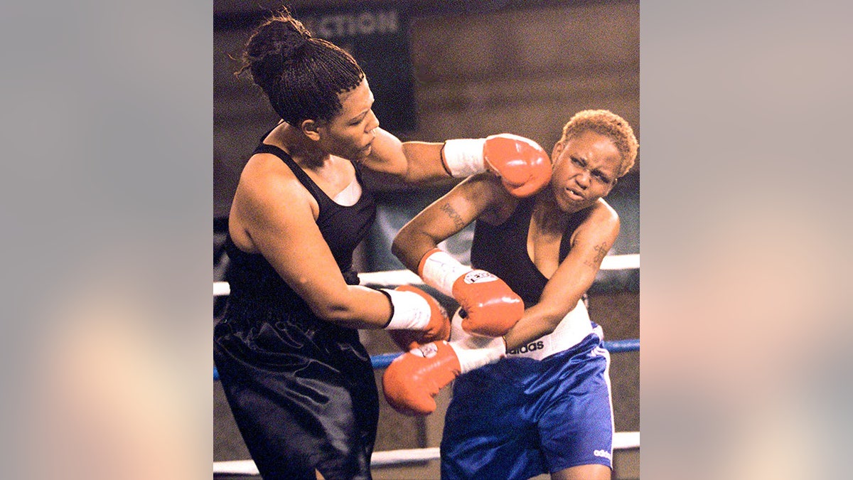 Freeda Foreman, left, daughter of former boxing champion George Foreman, lands a left to the head of LaQuanda Landers, right, in the first round of their pro debuts at the Regent Resort in Las Vegas, June 18, 2000. (John Gurzinski/AFP/Getty Images)