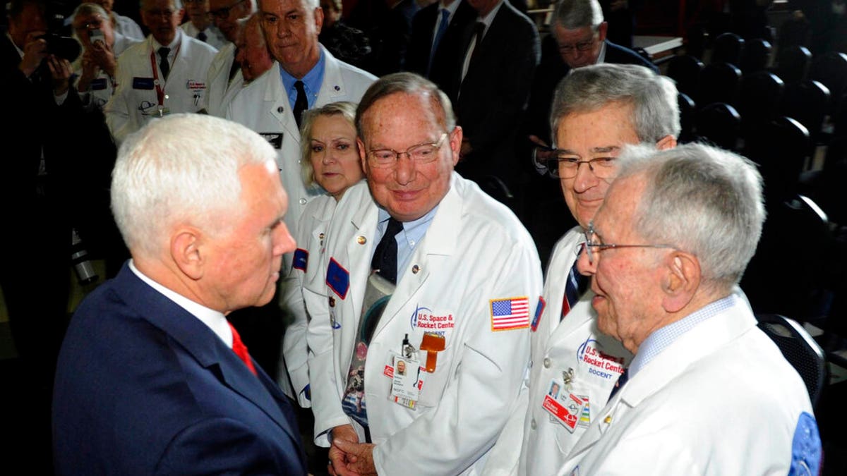 Vice President Mike Pence, left, speaking with museum docents at the National Space Council meeting held at the U.S. Space and Rocket Center. (Associated Press)