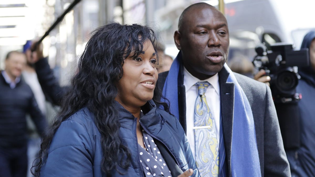 Tamara Lanier, left, and attorney Benjamin Crump, right arrive for a news conference near the Harvard Club Wednesday, March 20, 2019, in New York. Lanier, of Norwich, Conn., is suing the Harvard University for "wrongful seizure, possession and expropriation" of images she says depict two of her ancestors.