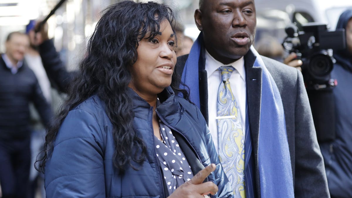 Tamara Lanier, left, and attorney Benjamin Crump, right arrive for a news conference near the Harvard Club Wednesday, March 20, 2019, in New York. Lanier, of Norwich, Conn., is suing the Harvard University for "wrongful seizure, possession and expropriation" of images she says depict two of her ancestors.