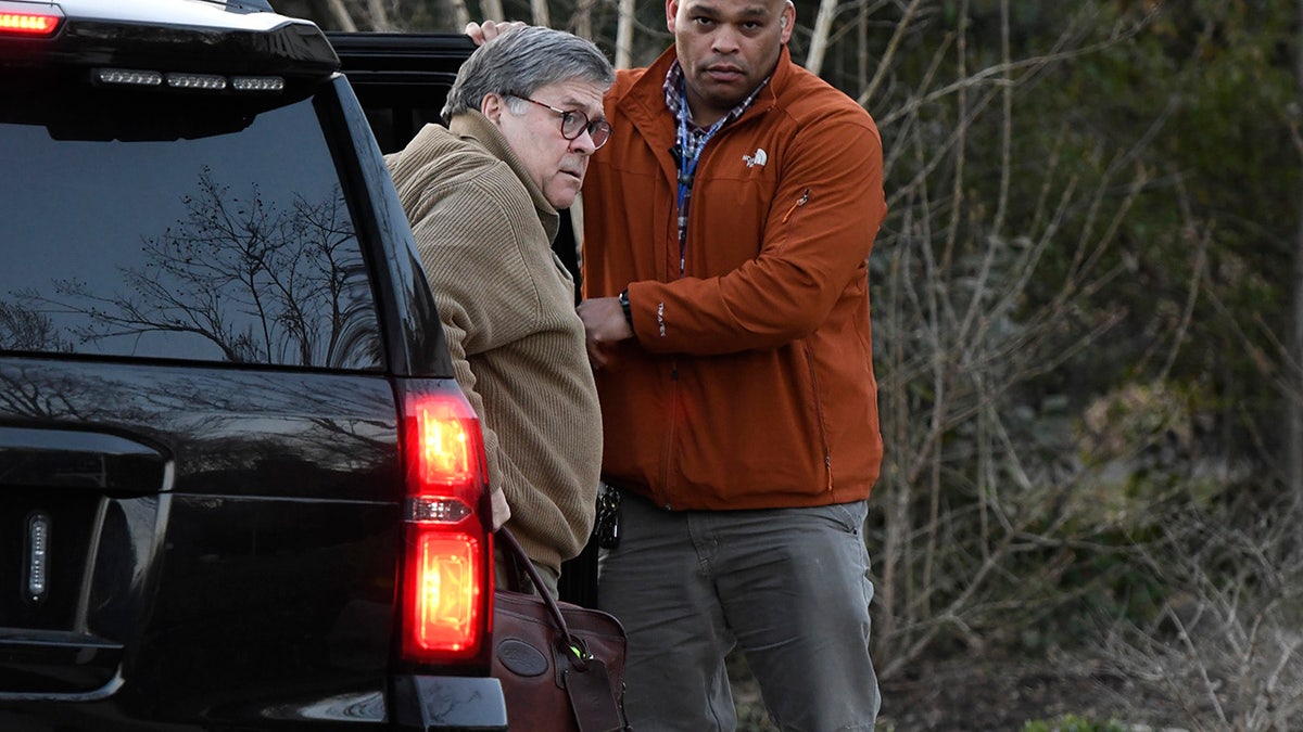U.S. Attorney General William Barr, left, arrives at his home in McLean, Va., on Saturday evening, March 23, 2019. Barr will decide how much of Special Counsel Robert Mueller's Russia investigation report will be released to Congress and the public. (Associated Press)
