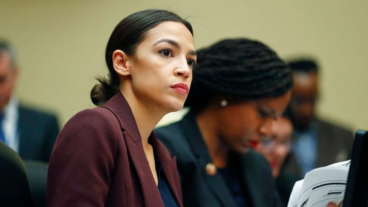 Rep. Alexandria Ocasio-Cortez, D-N.Y., left, looks over her notes during testimony by Michael Cohen, President Donald Trump's former lawyer, before the House Oversight and Reform Committee on Capitol Hill in Washington, Wednesday, Feb. 27, 2019. Sitting next to Ocasio-Cortez is Rep. Ayanna Pressley, D-Mass., right. (AP Photo/Pablo Martinez Monsivais)