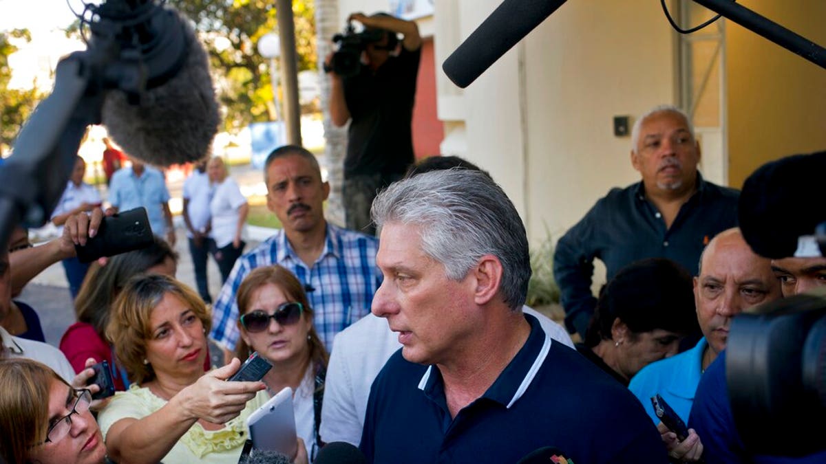 Cuba's President Miguel Diaz-Canel talks to the press after voting in a referendum to approve or reject the new constitution in Havana, Cuba, Sunday, Feb. 24, 2019. The constitutional reforms maintain Cuba's single-party political system and centrally planned economy while recognizing private property and small businesses, which have been part of the island's economy without formal legal status for more than a decade. (AP Photo/Ramon Espinosa)