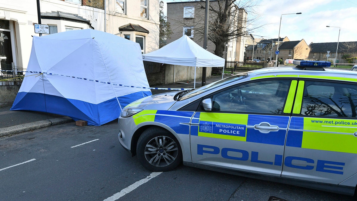 Police secure the area where a man was stabbed Wednesday evening, in the Leyton area of east London. Britain's Prime Minister Theresa May continues to face criticism over her refusal to accept an alleged link between reduced numbers of police officers, and increases of bloodshed on Britain's streets, as another man lost his life in a fatal stabbing in the capital. (John Stillwell/PA via AP)