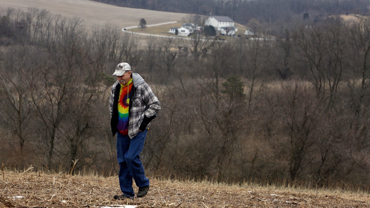 In this Saturday, Feb. 23, 2019 photo, Mike Carpenter, uncle of Greg Longenecker, walks the field where Longenecker was killed by a bulldozer in 2018