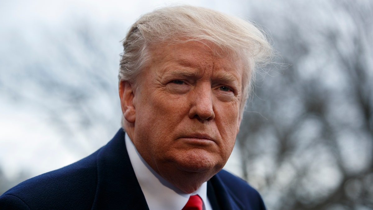 President Donald Trump listens to a question as he speaks with reporters before boarding Marine One on the South Lawn of the White House, Friday, March 22, 2019, in Washington.