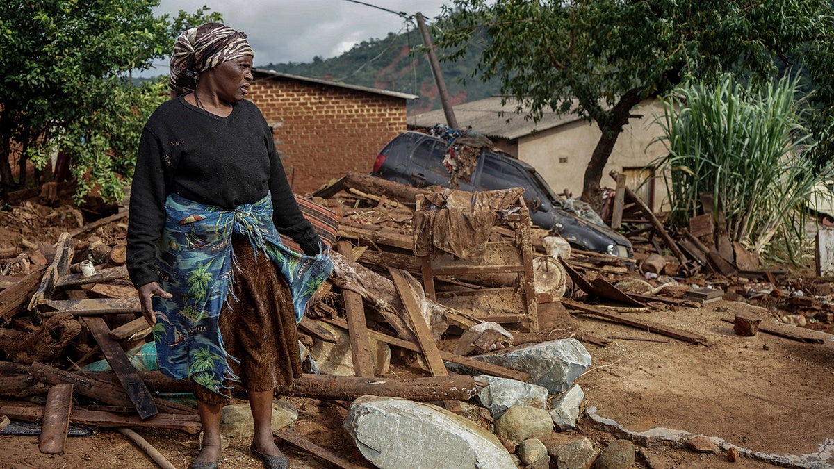 Jessica Mhonderi stands in front of what used to be her son's home in Chimanimani. Zimbabwe, Saturday, March 23, 2019. Mhonderi lost her daughter-in-law and three grandchildren to the Cyclone Idai induced rains last week that swept through Mozambique, Zimbabwe and Malawi.