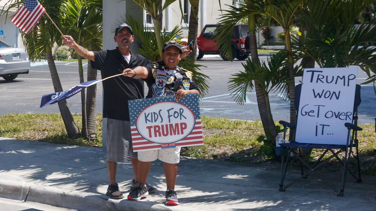 Supporters of President Donald Trump are seen from the media van in the motorcade accompanying the president in West Palm Beach, Fla., Saturday, March 23, 2019, en route to Mar-a-Lago in Palm Beach, Fla. (AP Photo/Carolyn Kaster)