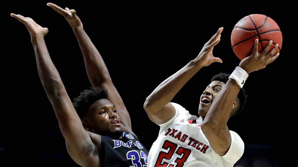 Texas Tech's Jarrett Culver (23) shoots past Buffalo's Nick Perkins (33) during the second half of a second-round men's college basketball game in the NCAA Tournament.