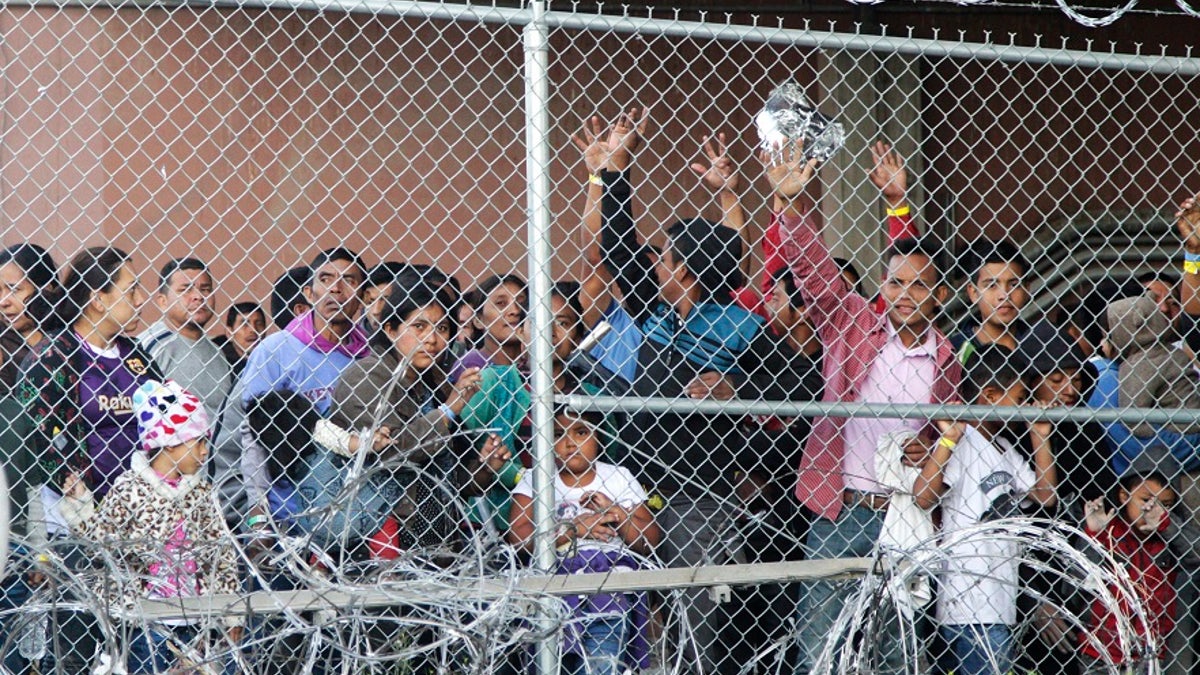 Central American migrants wait for food in El Paso, Texas on Wednesday in a pen erected by U.S. Customs and Border Protection to process a surge of migrant families and unaccompanied minors. (AP Photo/Cedar Attanasio)