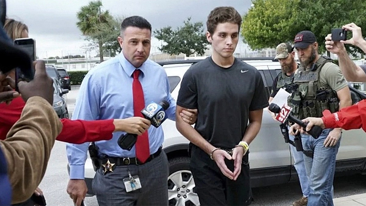 Austin Harrouff is transported by detectives to the Martin County jail from St. Mary's Hospital in Stuart, Fla.