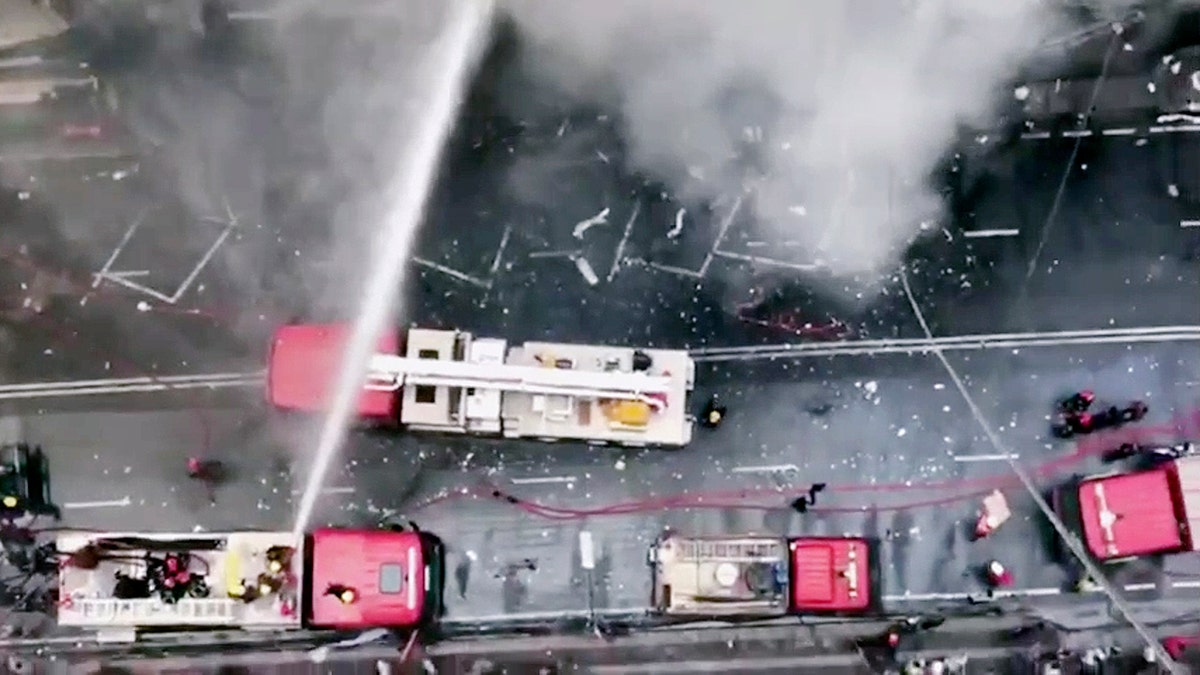 In this image made from video, firetrucks hose down a building on fire in the Banani area of Dhaka, Bangladesh, Thursday, March 28, 2019. An official in the Fire Department control room says the fire had broken out in an office building in Bangladesh's capital, and some people are feared trapped inside. (AP Photo)